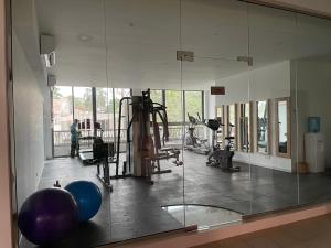 a gym with a mirror and some people in it at Apartment L4-5, Oceanfront Condos, Galle, Sri Lanka in Galle