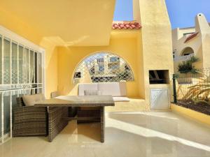 a patio with a table and a large window at Casa Drapa Costa Adeje in Adeje +56 photos
