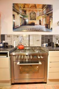 a kitchen with a stainless steel stove top oven at Baudan - Clim - Terrasse in Arles