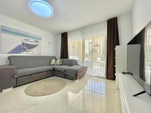 a living room with a couch and a flat screen tv at Casa Drapa Costa Adeje in Adeje