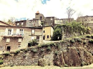 an old castle on top of a stone wall at Auberge de Chanteuges in Chanteuges