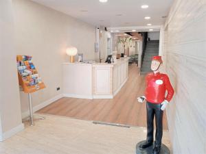 a figurine of a man in a red shirt in a room at Hotel 153 in Castelldefels