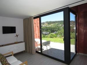 a living room with a sliding glass door to a patio at Paco de Pombeiro - Turismo de Habitacao in Felgueiras