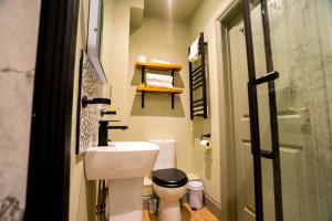 a small bathroom with a toilet and a sink at The Crown Hotel in Glastonbury