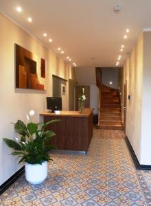 a lobby with a reception desk and a potted plant at Hotel Saline 3-Sterne Superior in Büdingen