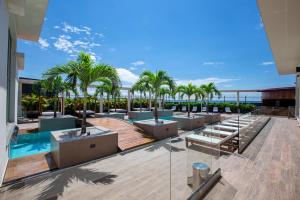 a resort with palm trees and a swimming pool at Panafrica Hotel Boutique & Spa in Bata