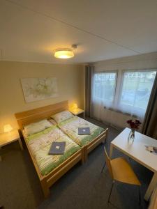 a bedroom with a bed with two books on it at Hostel U Sv. Štěpána in Litoměřice