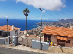 a view of the ocean from a house at A Slice of Paradise - Palheiro Golf in Funchal