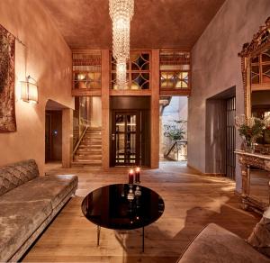 a living room with a couch and a table at Domus Renier Boutique Hotel in Chania