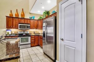 a kitchen with wooden cabinets and stainless steel appliances at Villa Vista in Hollister