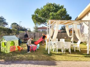 a couple of kids playing on a playground at La Meria di Maria Villa Rosa in Grosseto