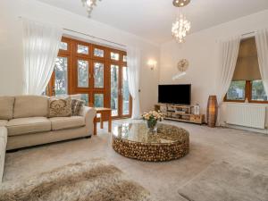 a living room with a couch and a coffee table at Mulberry House in Broadstone