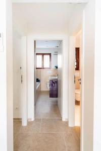 un corridoio che conduce a un bagno con servizi igienici di Villa Gai Coteau a Le Lavandou