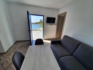 a living room with a couch and a table at EDEM HOUSE FINIKAS in Loutro