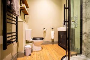 a bathroom with a toilet and a sink at The Crown Hotel in Glastonbury