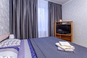 Кровать или кровати в номере Economy Brusnika Apartment Vykhino