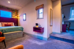 a bedroom with a bed and a table and chairs at The Crown Hotel in Glastonbury