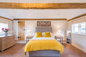 a bedroom with a large bed and two windows at Cart Lodge by Bloom Stays in Groombridge