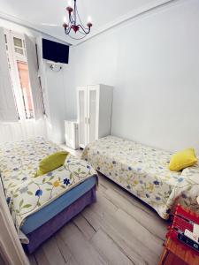 Postel nebo postele na pokoji v ubytování Pensión Antonio Guesthouse