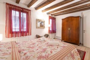 a bedroom with a large bed and red curtains at San Marco New Romantic in Venice