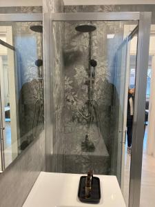 a shower in a room with a glass wall at Dolce Riposo in Cinisello Balsamo