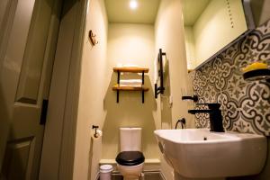 a bathroom with a sink and a toilet at The Crown Hotel in Glastonbury