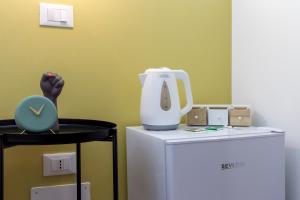a white mixer sitting on top of a refrigerator at Brand new guest room with Wi-Fi in the city center in Trieste