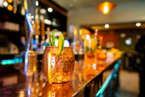 a vase with a plant in it sitting on a bar at The Crown Hotel in Glastonbury