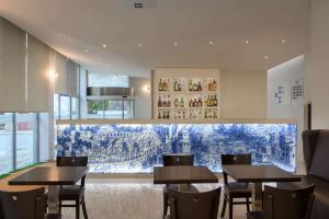 a dining room with tables and chairs in it at TRYP by Wyndham Porto Centro Hotel in Porto