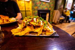 a plate of nacho chips on a table at The Crown Hotel in Glastonbury