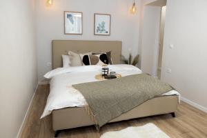 a bedroom with a large white bed with a table at Wanderer Center in Debrecen +32 photos