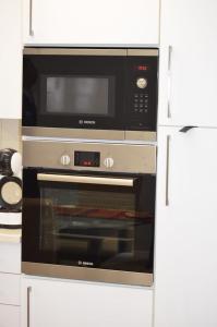 a microwave and a oven in a kitchen at Casa Bonita in Gaborone