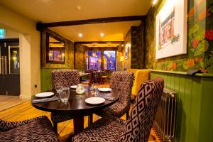 a dining room with a table and chairs at The Crown Hotel in Glastonbury