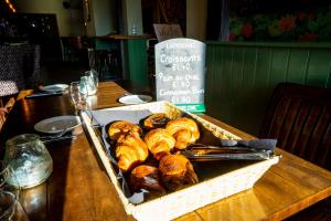 a basket of croissants sitting on a table at The Crown Hotel in Glastonbury