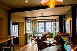 a dining room with tables and chairs in a restaurant at The Crown Hotel in Glastonbury