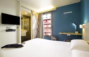a hotel room with a bed and a tv at B&B HOTEL Marseille Centre La Timone in Marseille