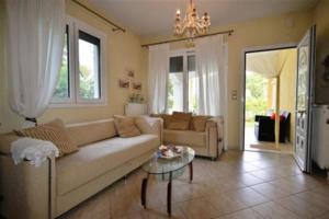 a living room with a couch and a table at Villa Alekos in Limenas