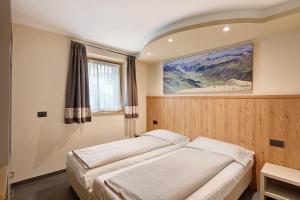 Postel nebo postele na pokoji v ubytování Rasia Residence Relax Mountain