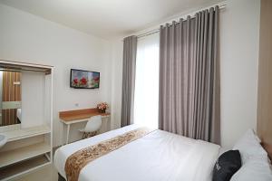 Katil atau katil-katil dalam bilik di Ngampilan Residence Yogyakarta Mitra RedDoorz