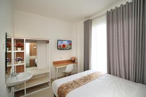 Katil atau katil-katil dalam bilik di Ngampilan Residence Yogyakarta Mitra RedDoorz
