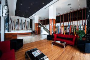 a lobby with a red couch and surfboards on the wall at Effotel By Sayaji Indore in Indore