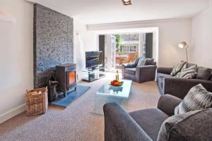 a living room with a couch and a fireplace at Goshen Cottage in Kelso