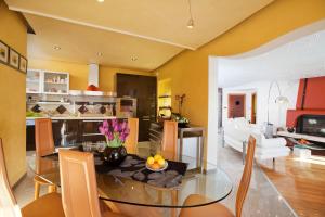 a dining room and living room with a glass table at Villa Rosa in Labin