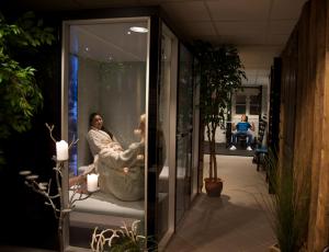 a woman sitting in a chair in a window at Sølvgarden Hotel in Rysstad