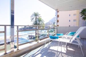 a balcony with chairs and a view of the ocean at Frentemar 2 Deluxe in Calpe