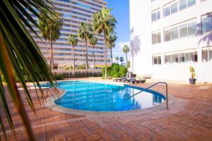 a swimming pool in front of a building at Frentemar 2 Deluxe in Calpe