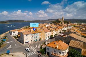 an aerial view of a town next to the water at Alcôve Marine in Gruissan