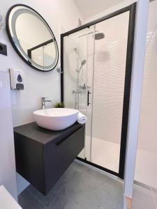 a bathroom with a sink and a mirror at Apartment STAR Blažev in Primošten +37 photos