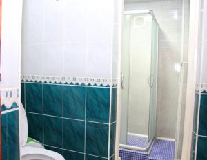 a bathroom with a toilet and a glass shower at BEST GUESTHOUSE in Tashkent