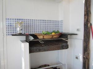 a basket of fruit on a shelf in a kitchen at Relais Bijoux Ischia in Ischia